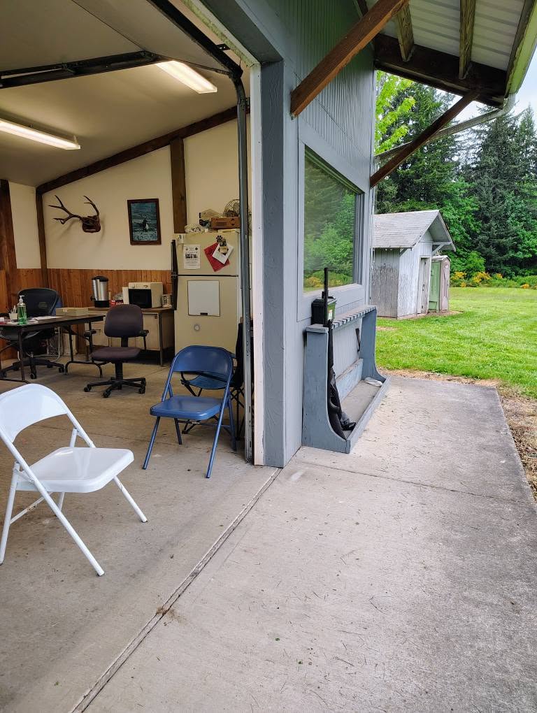 Inside the clubhouse: chairs, a desk, a fridge, antlers on the wall